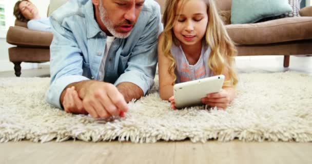 父亲和女儿在客厅中使用数字平板电脑 — 图库视频影像