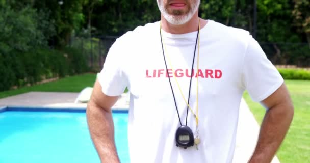 Lifeguard standing at pool side — Stock Video