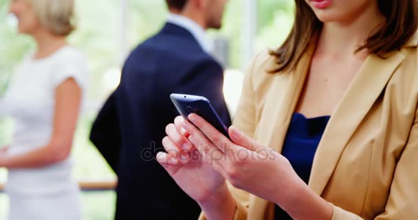 Mensajería de texto ejecutiva femenina en el teléfono móvil — Vídeo de stock