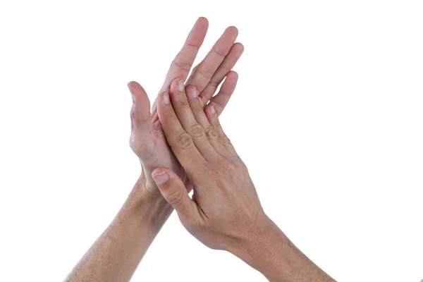 Mãos com as palmas das mãos esfregando juntos contra fundo branco — Fotografia de Stock