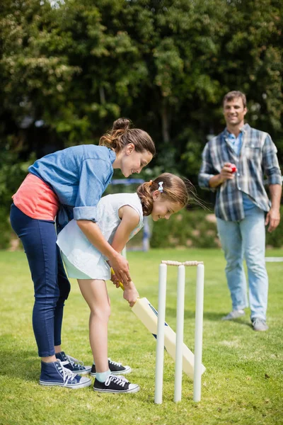 Family playing cricket in park — Stock Photo, Image