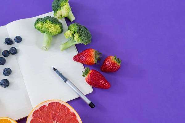 Nastro di misurazione, frutta, verdura, libro aperto e penna — Foto Stock