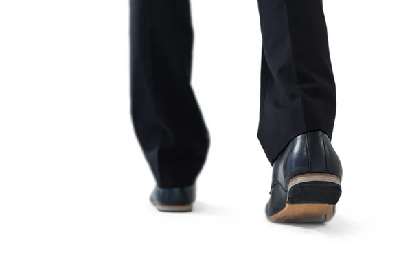 Businessman walking on while background — Stock Photo, Image