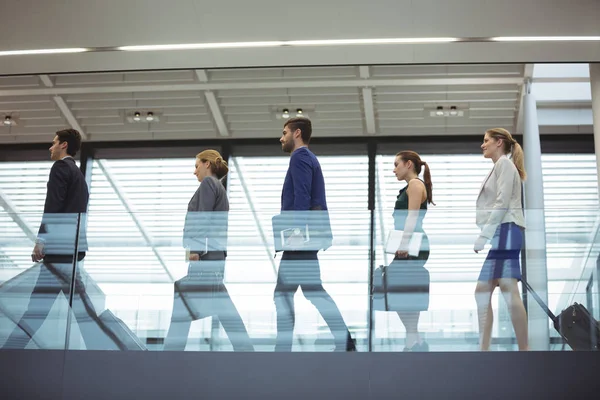 Business executives with trolley bag walking — Stock Photo, Image