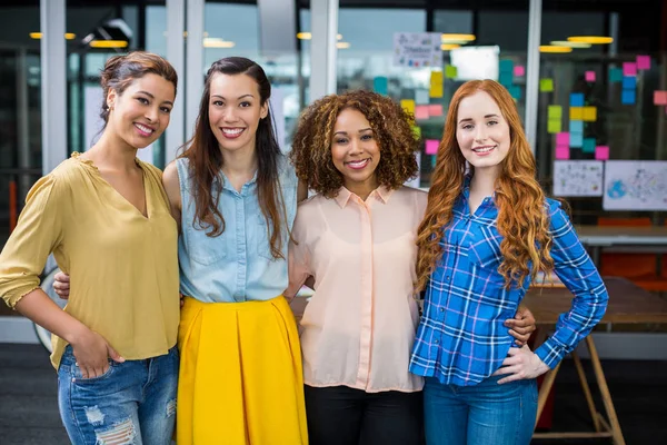 Portrait of smiling female executives standing together — Stock Photo, Image