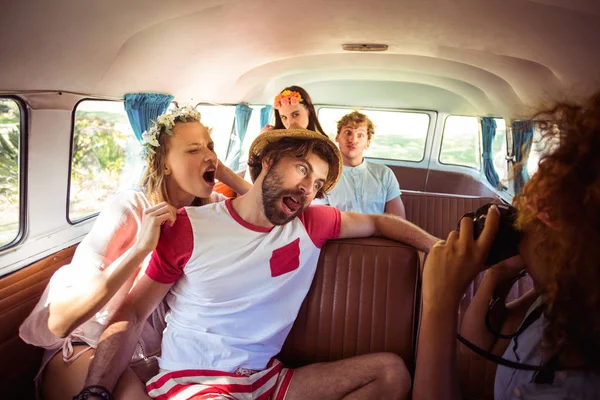 Woman taking a picture of her friends in campervan — Stock Photo, Image