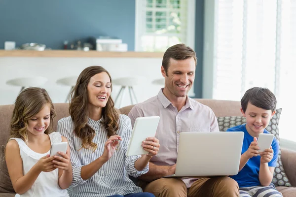 Family using digital tablet, phone and laptop — Stock Photo, Image