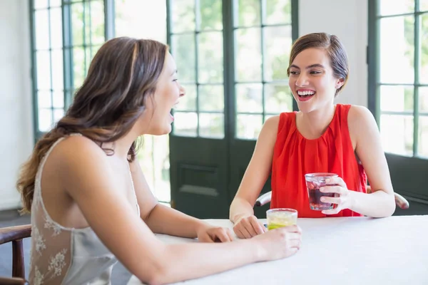 Friends laughing while having cocktails — Stock Photo, Image