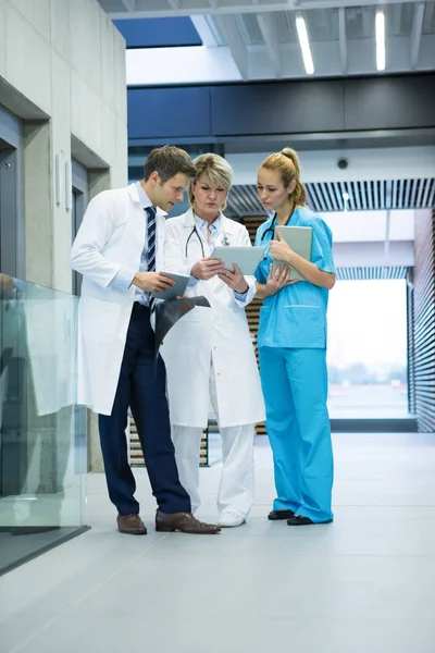 Medical team discussing over digital tablet — Stock Photo, Image