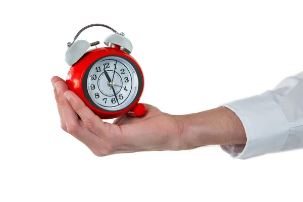 Hand voor uitvoerend bedrijf alarm clock — Stockfoto