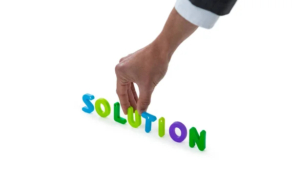 Hand of businessman arranging solution word — Stock Photo, Image