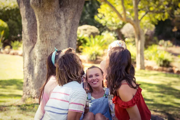 Group of friends lifting woman at campsite — Stock Photo, Image