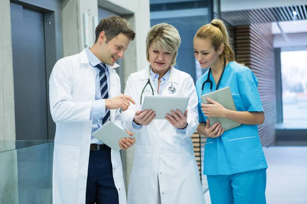 Medical team discussing over tablet — Stock Photo, Image