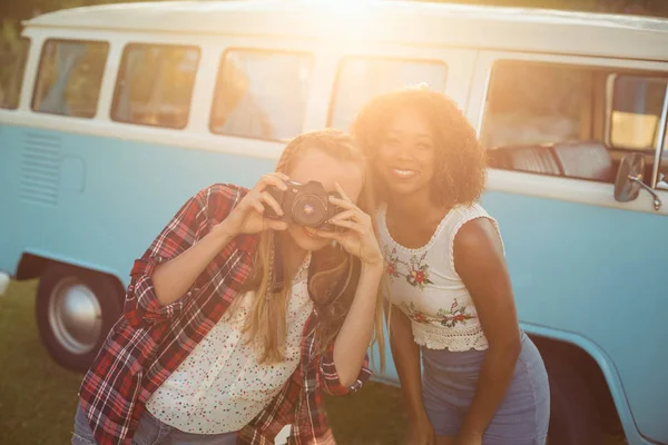 Two smiling friends photographing with camera — Stock Photo, Image