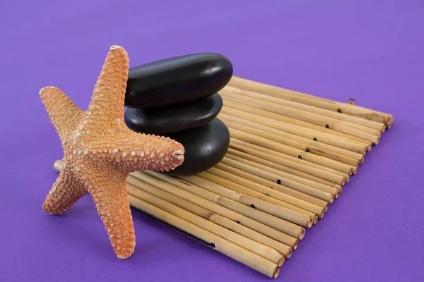 Zen stones with star fish on bamboo mat — Stock Photo, Image