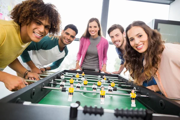 Happy executives playing table football — Stock Photo, Image