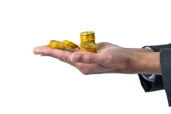 Mid section of businessman holding gold coins — Stock Photo, Image