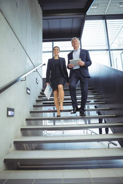 Business executives climbing down the stairs — Stock Photo, Image