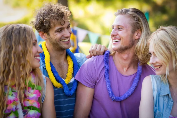 Friends interacting with each other in park — Stock Photo, Image