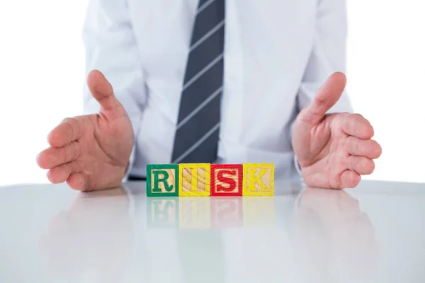 Businessman showing a word RISK — Stock Photo, Image