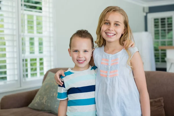 Schwester und Bruder stehen mit den Armen herum — Stockfoto