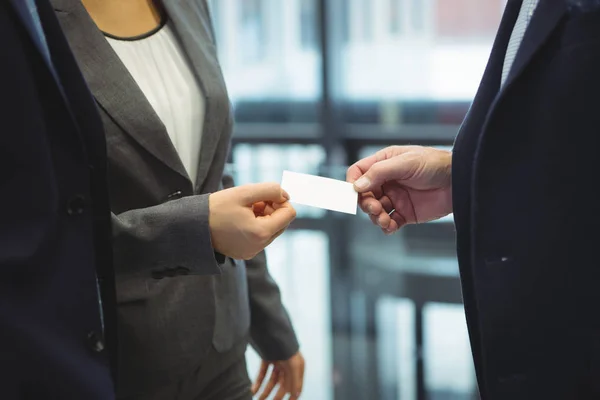 Business executives giving business cards — Stock Photo, Image