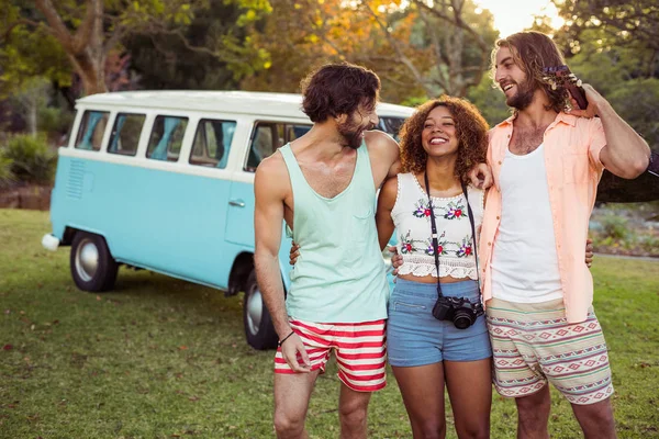 Three friends standing together near campervan — Stock Photo, Image