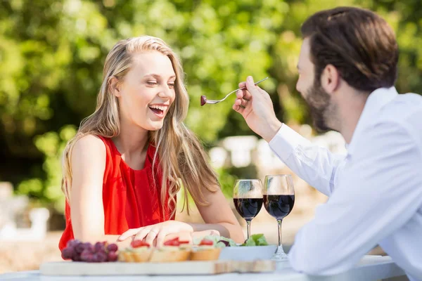 Man feeding a woman with fork — Stock Photo, Image