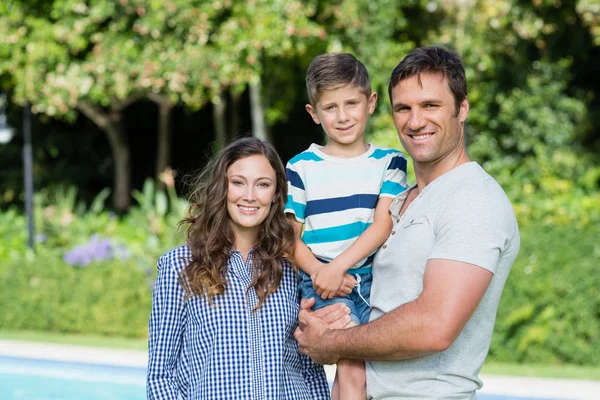 Smiling family standing together in park — Stock Photo, Image