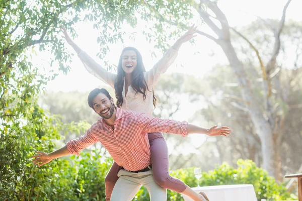 Homem dando passeio de piggyback para mulher no restaurante — Fotografia de Stock