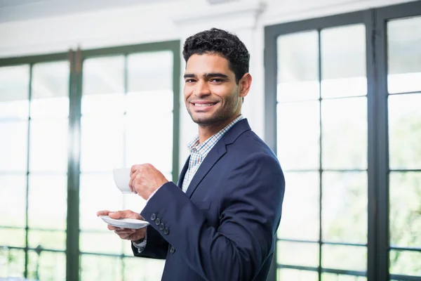 Portrait of businessman holding coffee cup — Stock Photo, Image