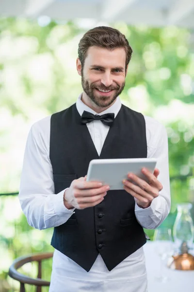 Garçom masculino segurando tablet digital — Fotografia de Stock
