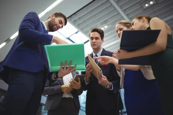 Business executives discussing reports — Stock Photo, Image