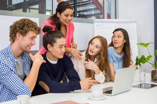 Executives discussing over laptop in conference room — Stock Photo, Image