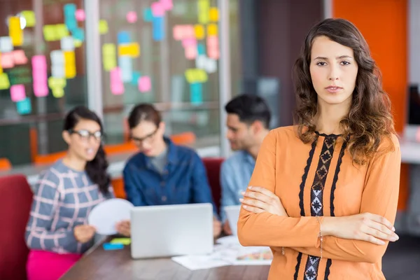 Portrait of female graphic designer standing with arms crossed — Stock Photo, Image