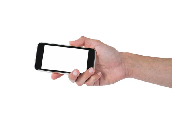 Mãos segurando um telefone celular contra fundo branco — Fotografia de Stock