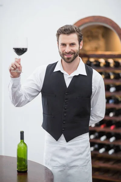 Male waiter holding wine glass in the restaurant — Stock Photo, Image