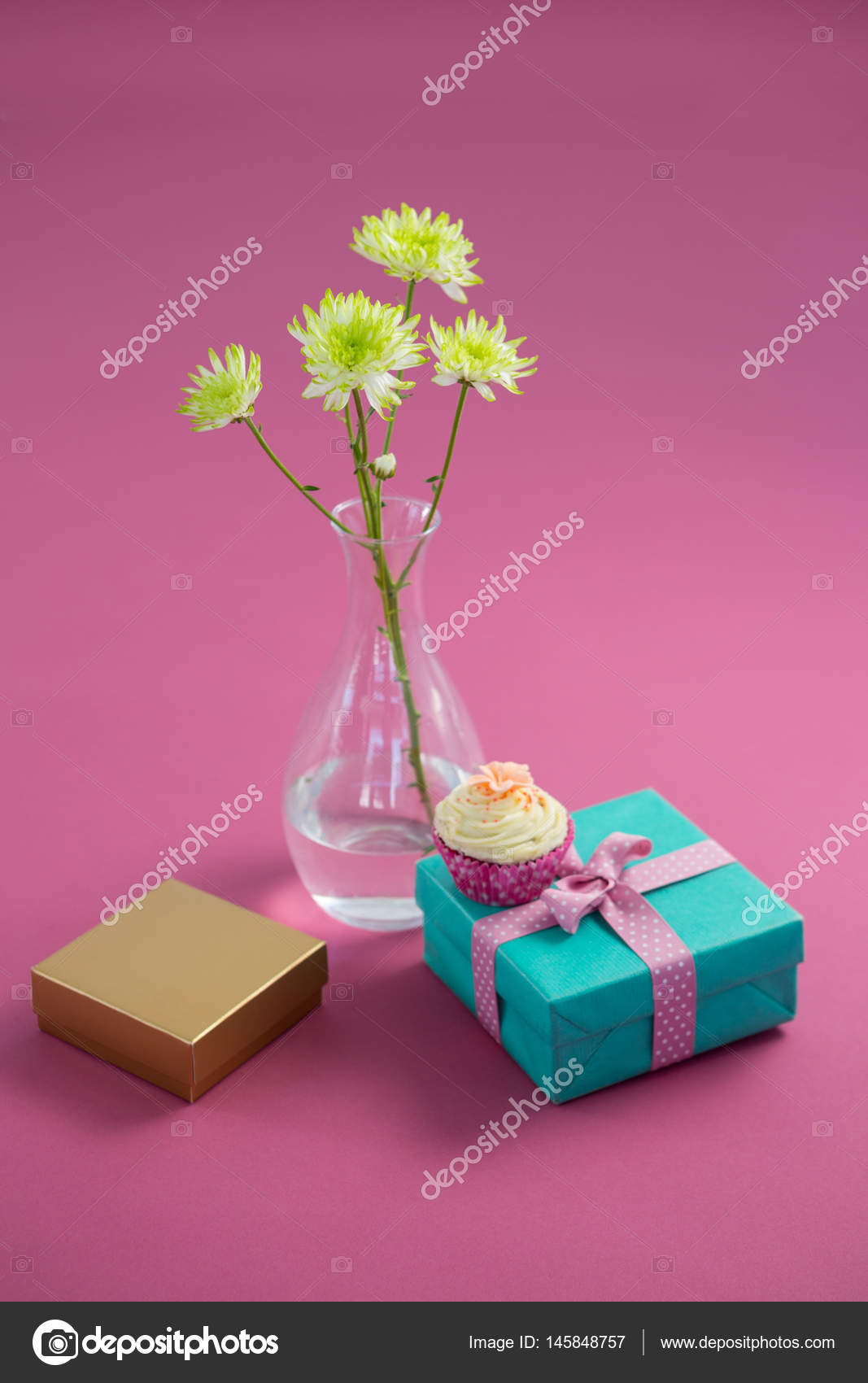 Flower Vase And Cupcake With Gift Boxes Against Pink Background