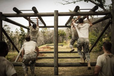 Soldiers climbing monkey bars clipart