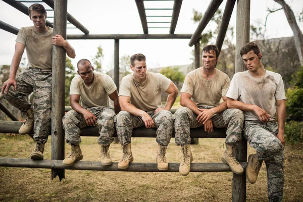 Soldiers sitting on the obstacle course — Stock Photo, Image