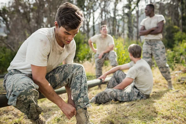 Soldier tying his shoe laces — Stock Photo, Image