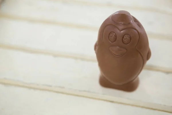 Chocolate Easter egg on wooden plank — Stock Photo, Image