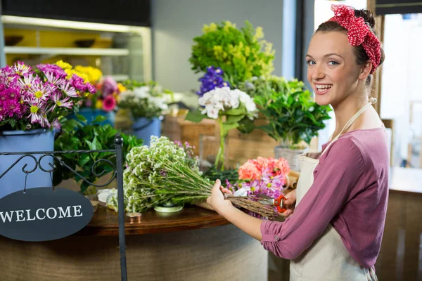 Floristería femenina preparando ramo de flores en la tienda de flores — Foto de Stock