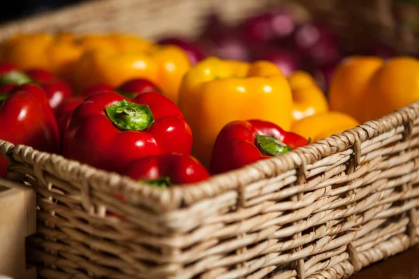 Bell peppers in wicker basket — Stock Photo, Image