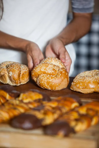 Frau in der Mitte hält Brot am Tresen — Stockfoto