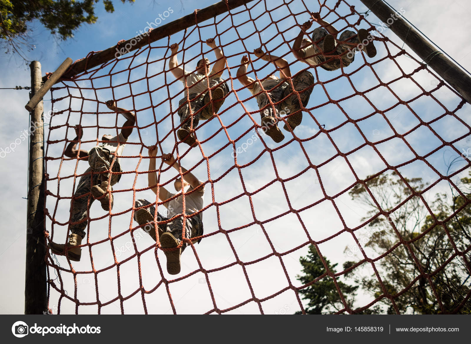 Military soldiers climbing rope during obstacle course — Stock Photo ...