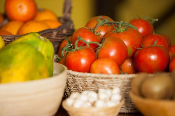 Juicy tomatoes and fruits in organic section — Stock Photo, Image