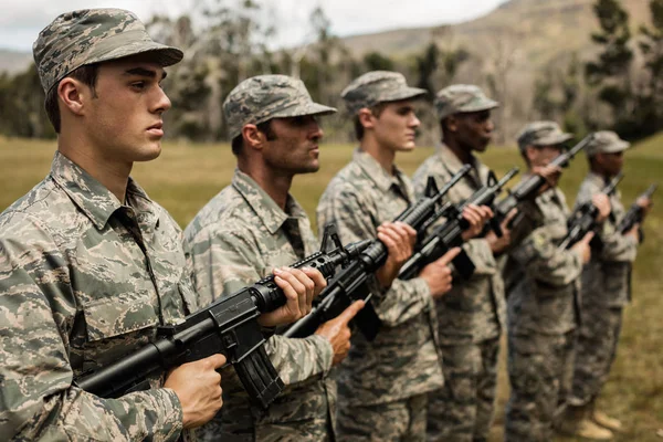 Group of military soldiers standing with rifles — Stock Photo, Image