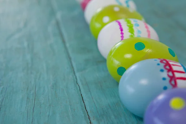 Various Easter eggs arranged on wooden surface — Stock Photo, Image