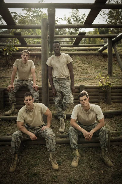 Soldiers sitting on the obstacle course in boot camp — Stock Photo, Image